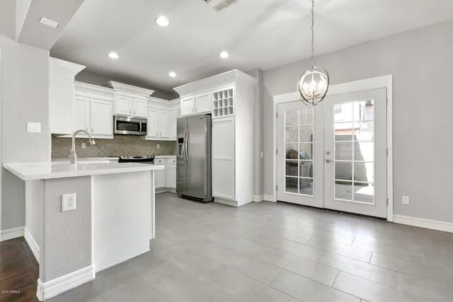 a kitchen with stainless steel appliances a refrigerator sink and microwave