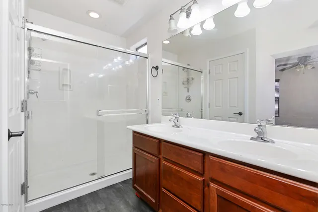 a bathroom with a sink double vanity and shower