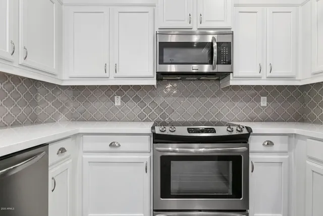 a stove top oven sitting inside of a kitchen