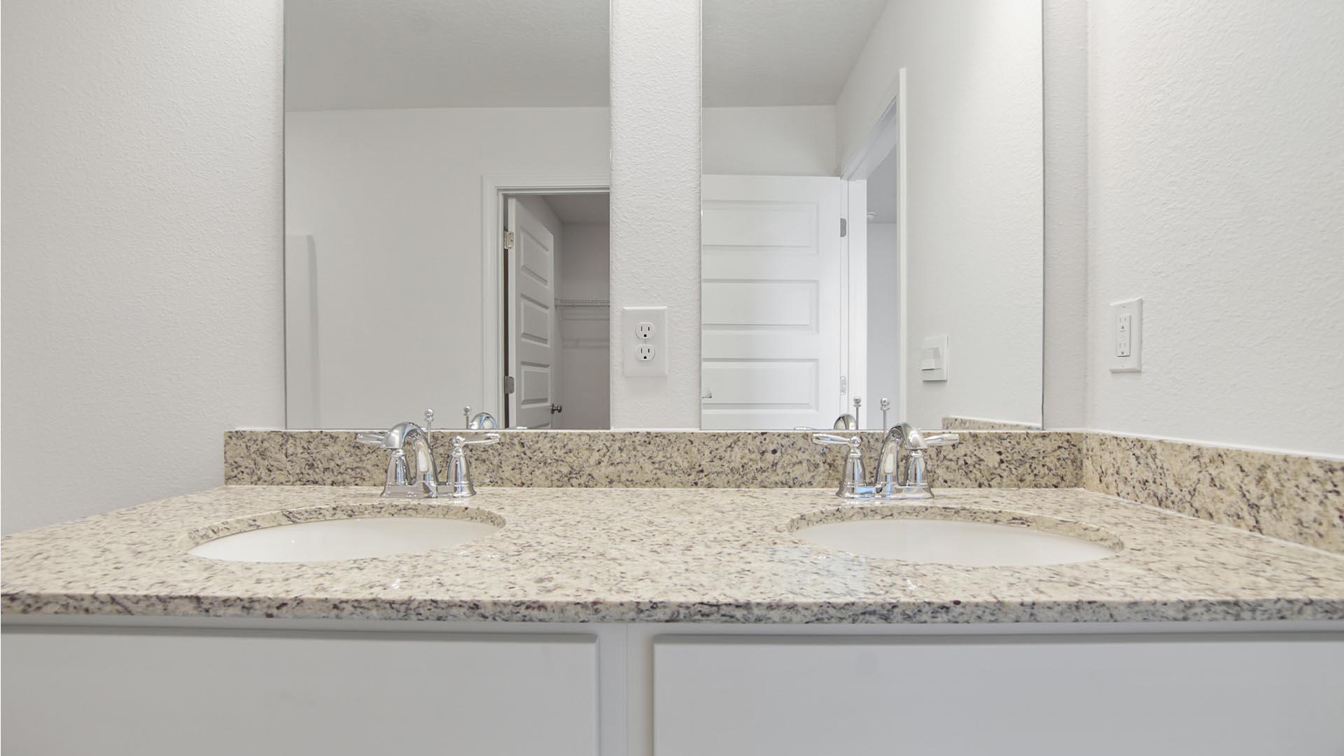 226 Huckleberry Street Freeport, FL 32439 - Photo 12 of 32 a bathroom with a granite countertop sink and a mirror