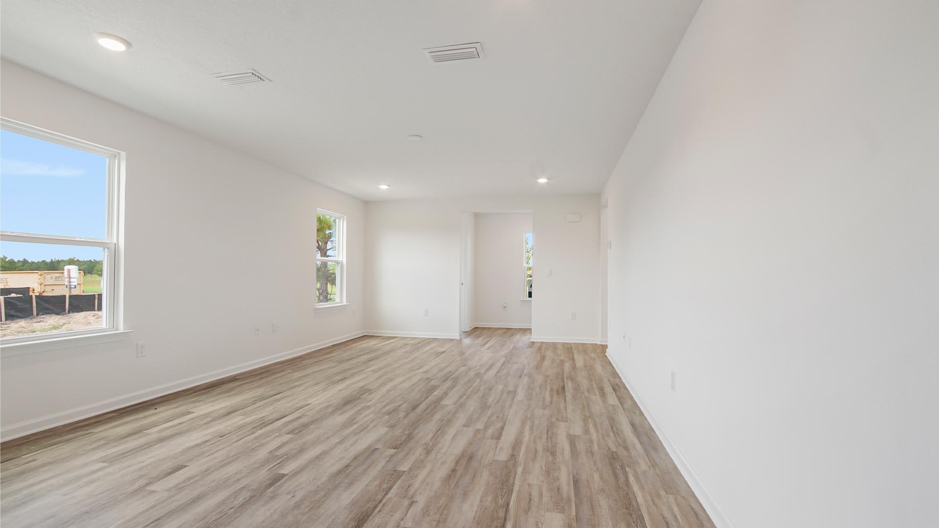 226 Huckleberry Street Freeport, FL 32439 - Photo 15 of 32 an empty room with wooden floor and windows