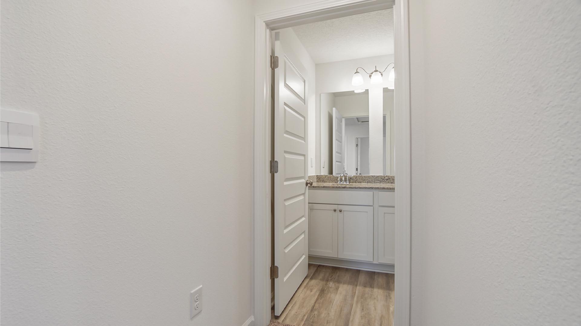 226 Huckleberry Street Freeport, FL 32439 - Photo 21 of 32 a bathroom with a light fixture a mirror and a sink