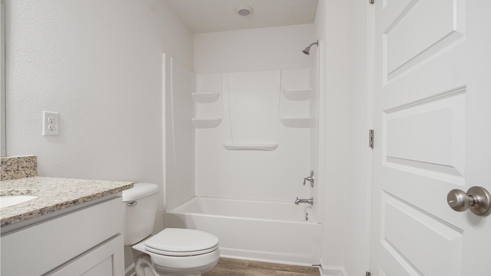 226 Huckleberry Street Freeport, FL 32439 - Photo 23 of 32 a bathroom with a sink toilet and shower