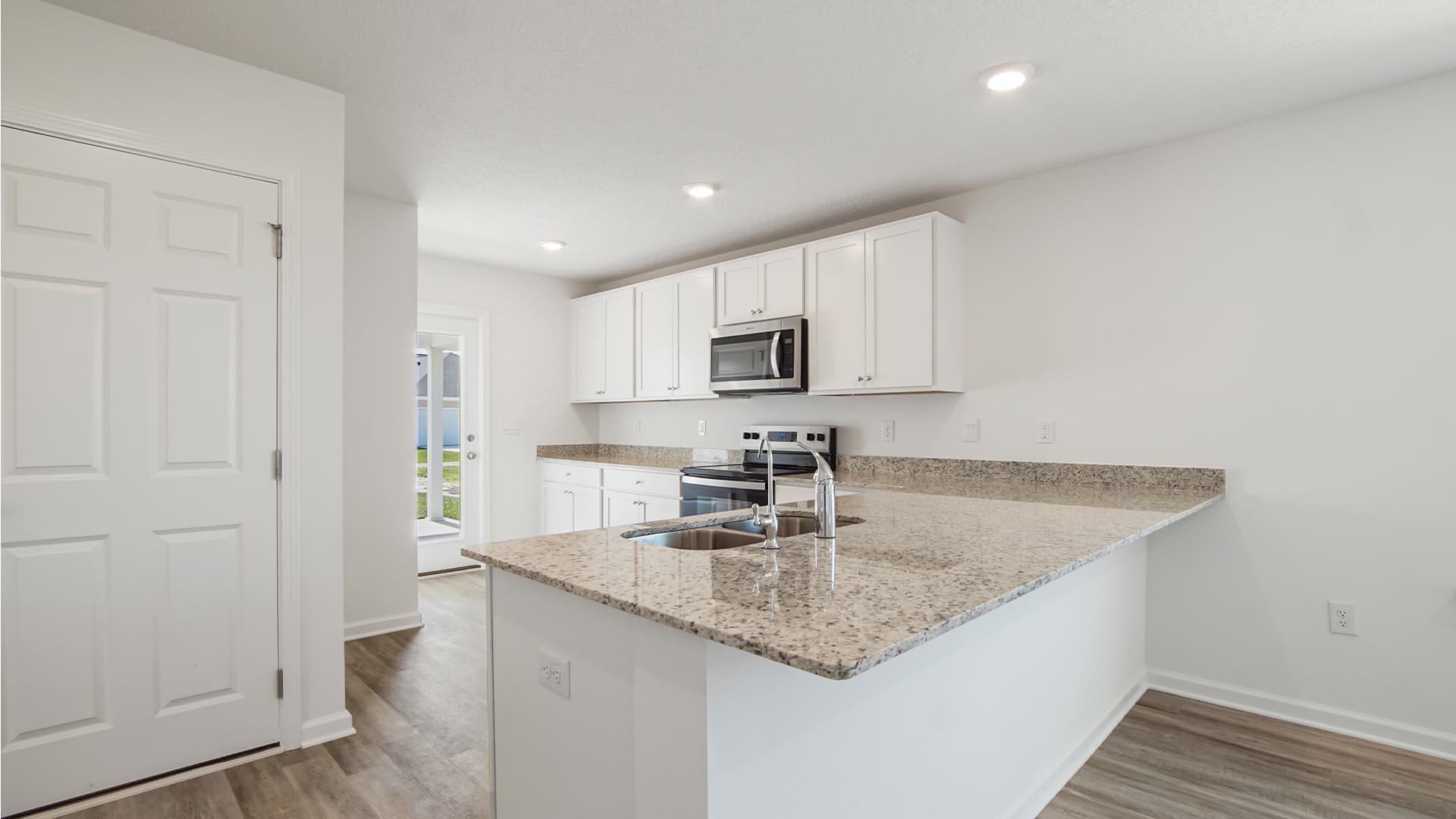 226 Huckleberry Street Freeport, FL 32439 - Photo 6 of 32 a kitchen with stainless steel appliances granite countertop a sink a refrigerator and a granite counter tops