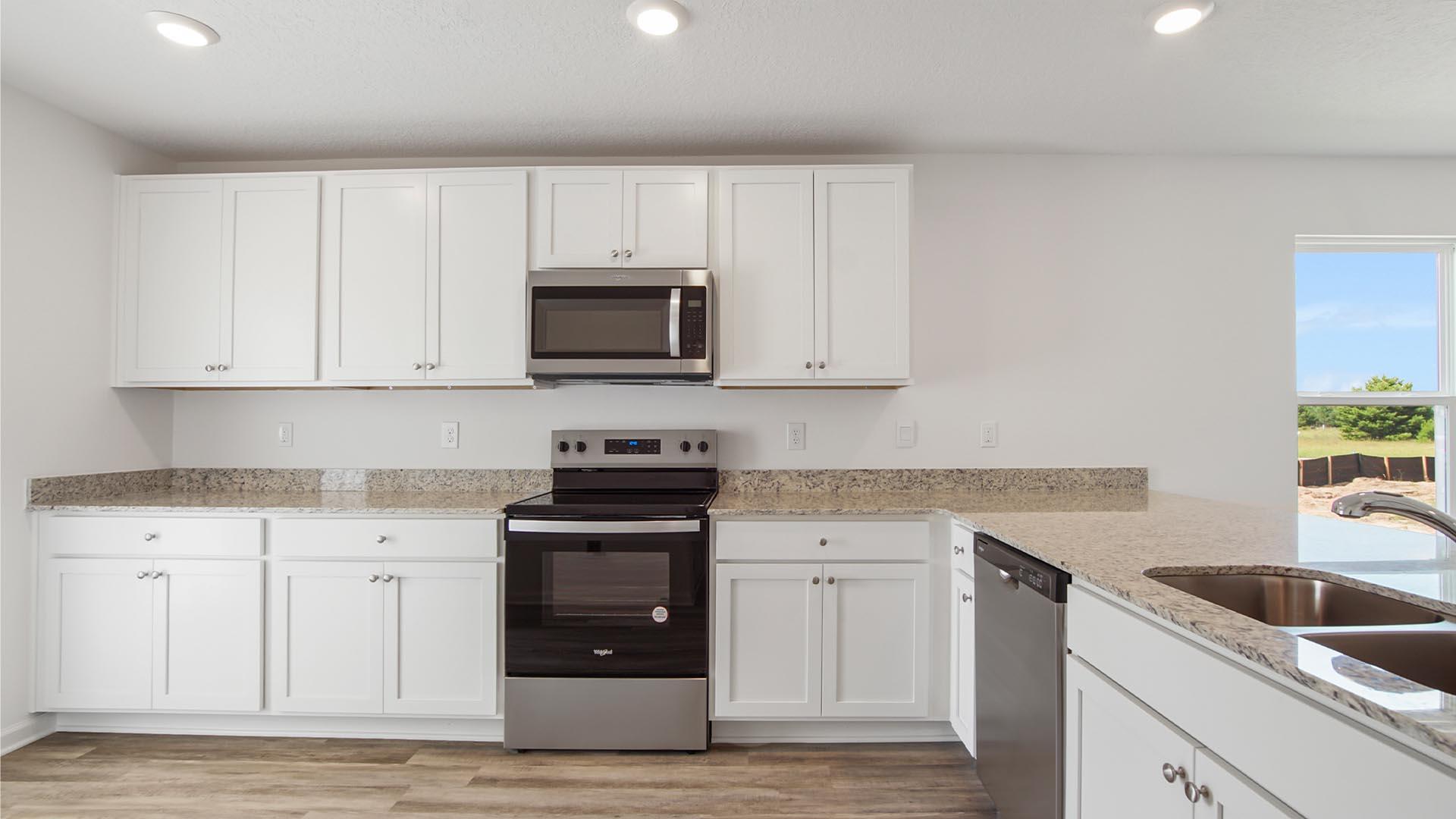 226 Huckleberry Street Freeport, FL 32439 - Photo 7 of 32 a kitchen with sink a microwave and cabinets