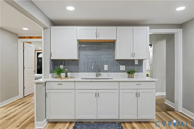 a kitchen with stainless steel appliances a sink stove and cabinets