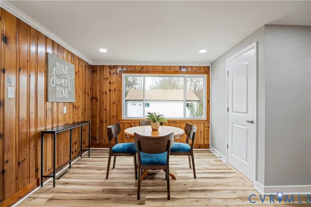 a dining room with furniture window and wooden floor