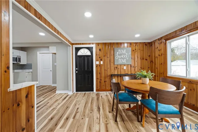 a dining room with furniture and wooden floor