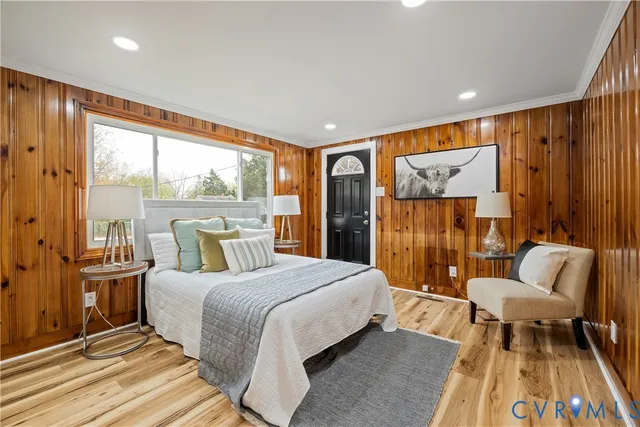 a bedroom with a bed and a large window