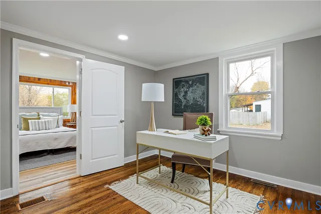 a dining room with wooden floor and a table
