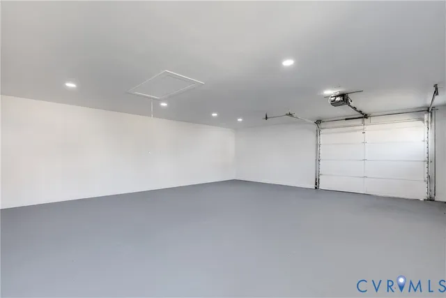 an empty room with white walls and ceiling fan