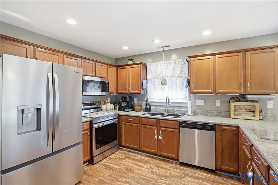 19012 Teman Road Beaverdam, VA 23015 - Photo 11 of 41 a kitchen with granite countertop stainless steel appliances a sink cabinets and a window
