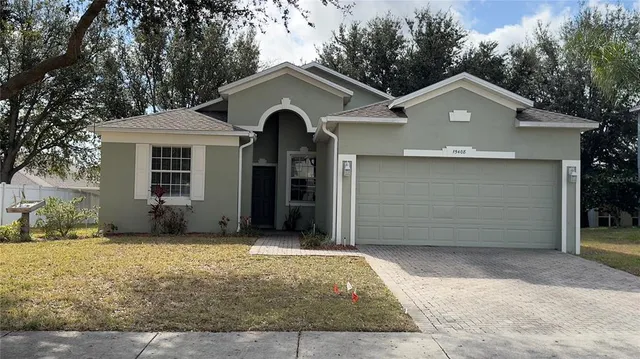 a front view of a house with a yard and garage