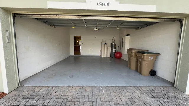 a kitchen with a sink a counter top space stainless steel appliances and cabinets