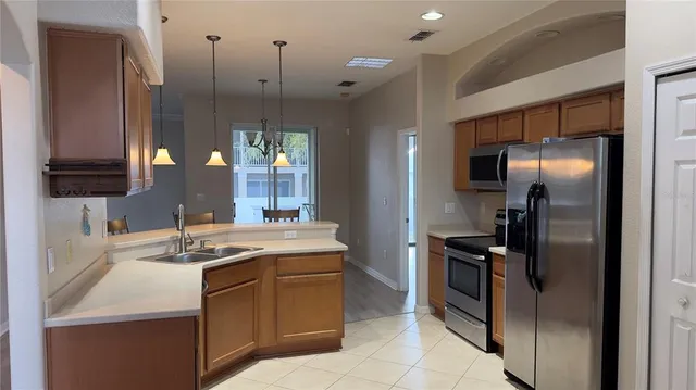 a kitchen with stainless steel appliances granite countertop a refrigerator and a sink