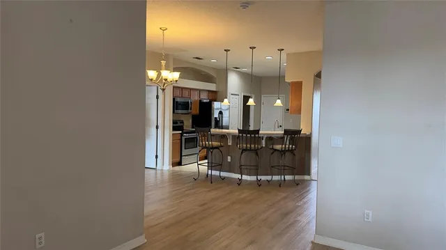 a large kitchen with stainless steel appliances a refrigerator and a sink