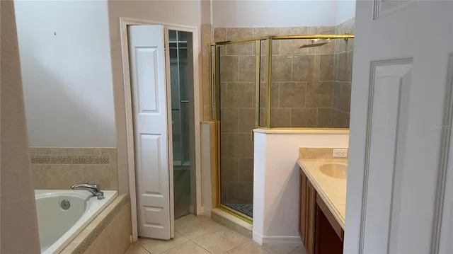 an empty room with wooden floor mirror and windows