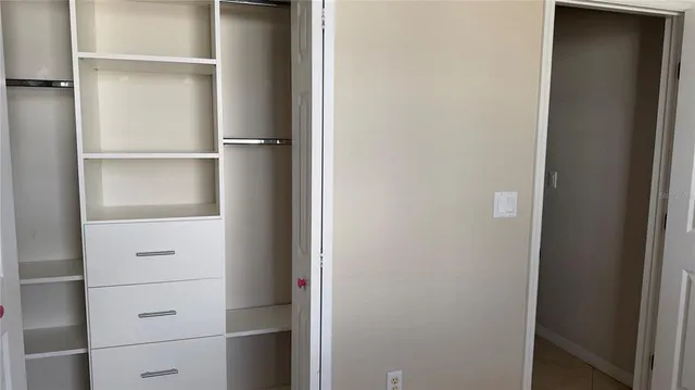 a view of a park with a lounge chair and wooden fence