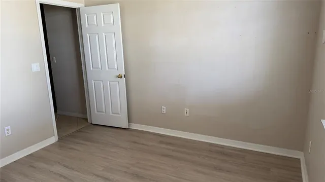 a view of a porch with furniture and wooden floor