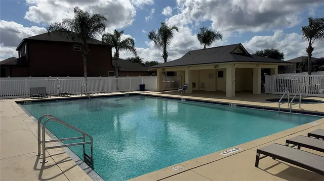 a view of lake with green yard