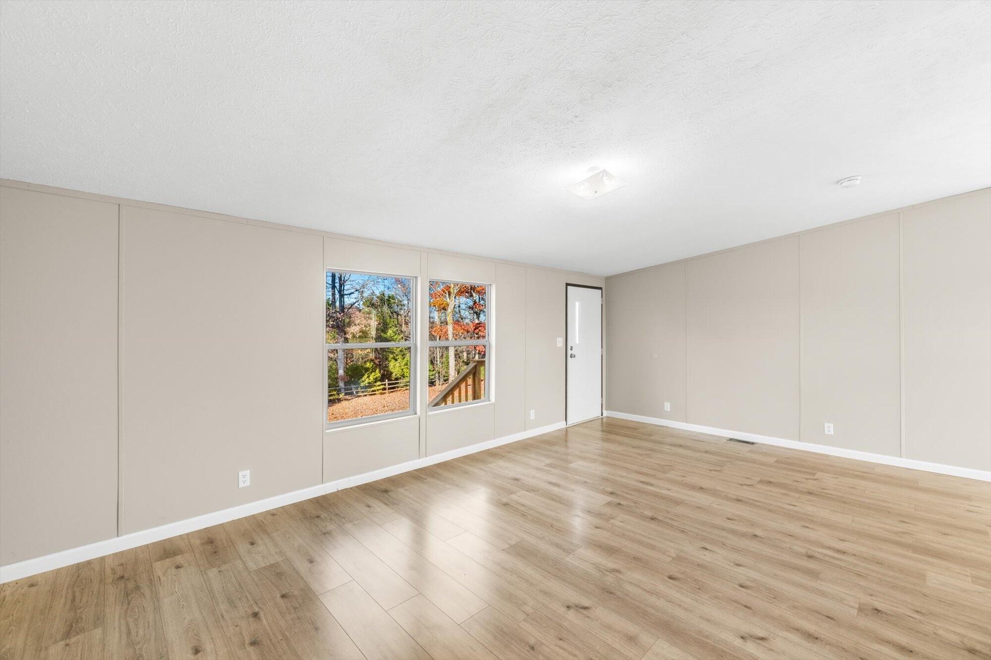1202 Green Pond Road Decatur, TN 37322 - Photo 7 of 28 a view of an empty room with wooden floor and a window