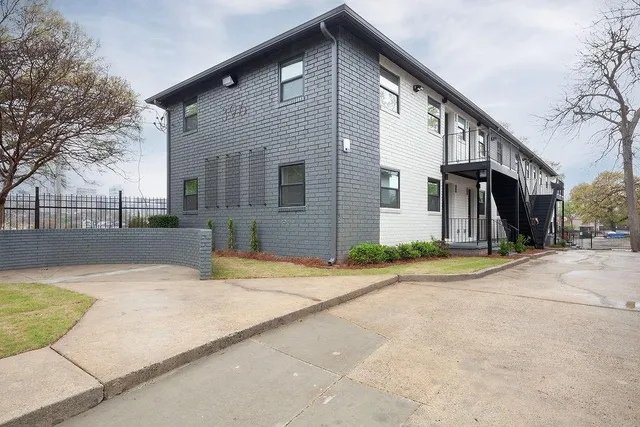 a backyard of a house with garage and glass windows
