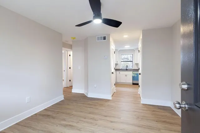 a view of a kitchen with wooden floor and a kitchen