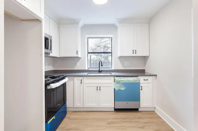 a kitchen with stainless steel appliances granite countertop a stove and cabinets