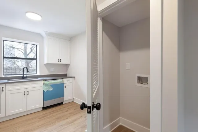 a kitchen with a sink cabinets and window
