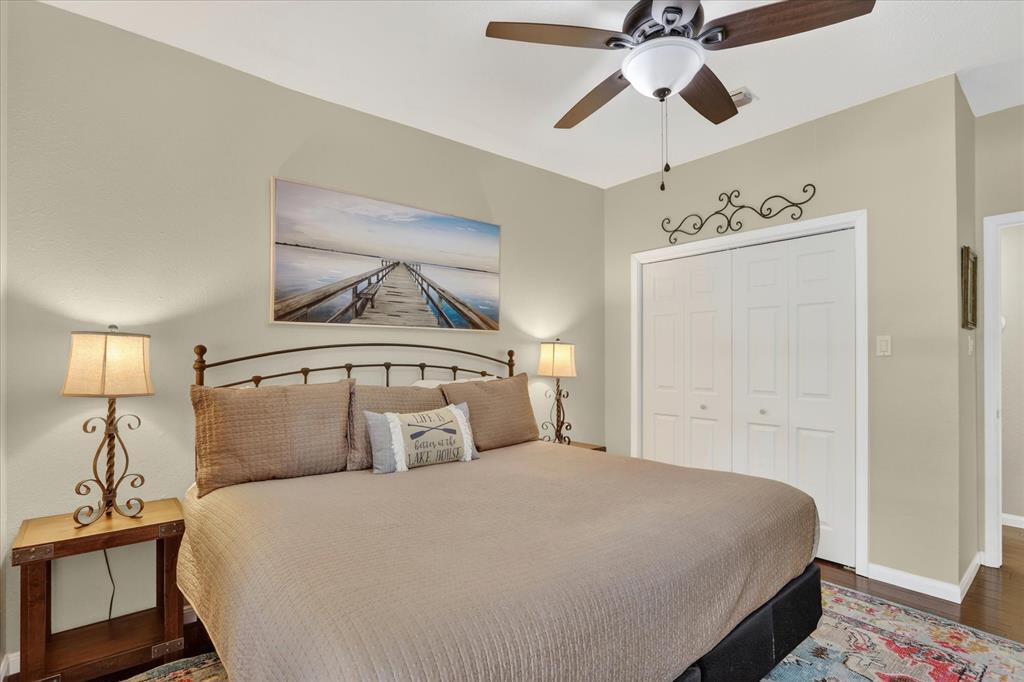 8877 Random Road Fort Worth, TX 76179 - Photo 19 of 40 a bedroom with a bed and a chandelier