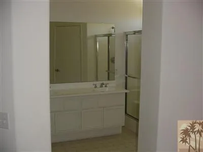 a bathroom with a shower and a sink