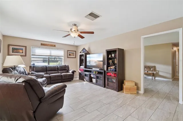 a kitchen with a sink a refrigerator and cabinets