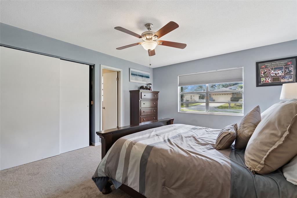 1547 Center Street DeLand, FL 32720 - Photo 19 of 37 a bedroom with a large bed and a chandelier