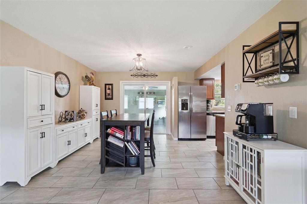 1547 Center Street DeLand, FL 32720 - Photo 8 of 37 a kitchen with cabinets and chairs