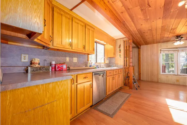 a kitchen with granite countertop lots of counter top space and windows