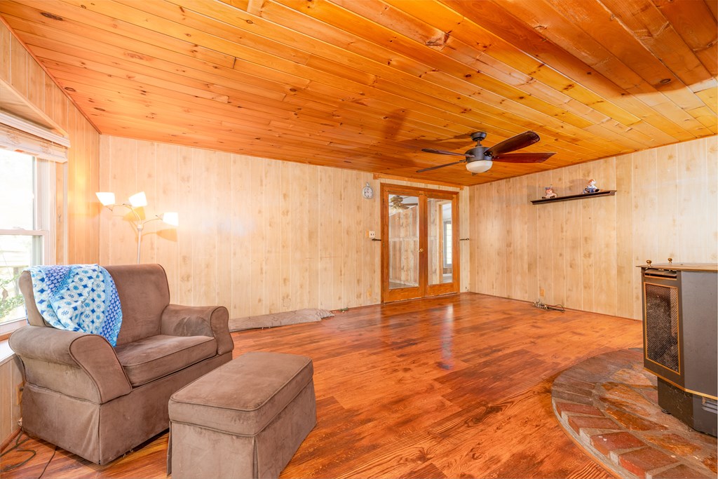 103 Cove Lane Murphy, NC 28906 - Photo 7 of 15 a living room with furniture a flat screen tv and a floor to ceiling window