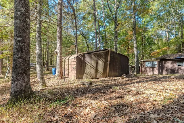 a view of a barn in the middle of a yard