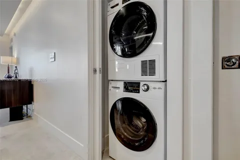 a view of a hallway with washer and dryer