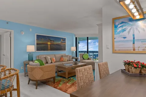 a bedroom with a bed and large windows