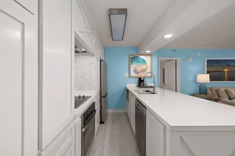 a bedroom with a large bed and a flat tv screen on dresser