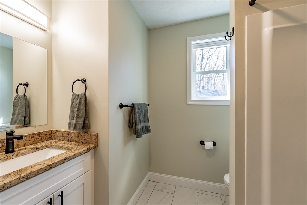 20 Ormond Drive Northampton, MA 01062 - Photo 25 of 32 a bathroom with a granite countertop sink and a mirror