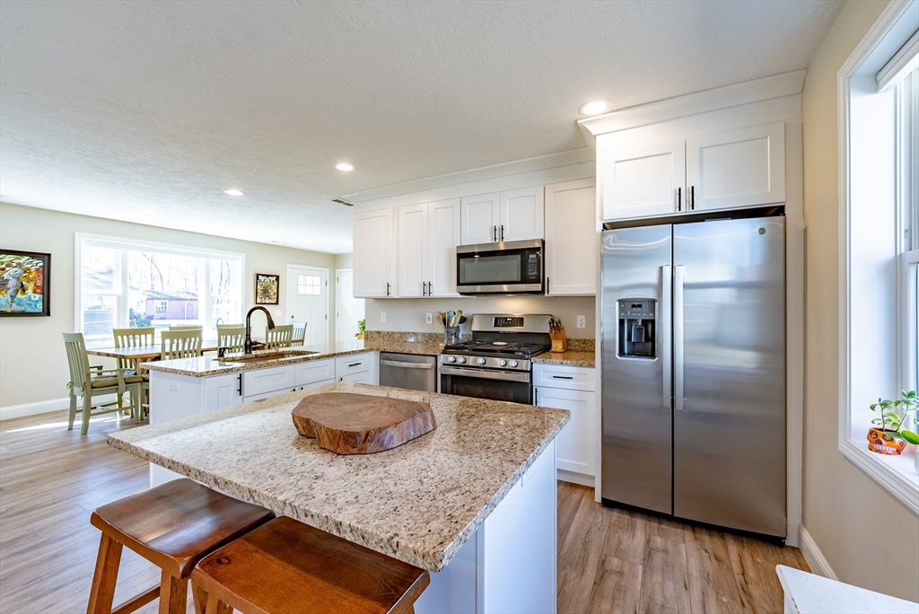 20 Ormond Drive Northampton, MA 01062 - Photo 10 of 32 a kitchen with a refrigerator a stove a sink a counter space and dining table