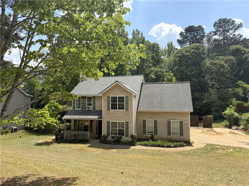 7251 Williams Road Flowery Branch, GA 30542 - Photo 1 of 10 a front view of a house with trees in the background