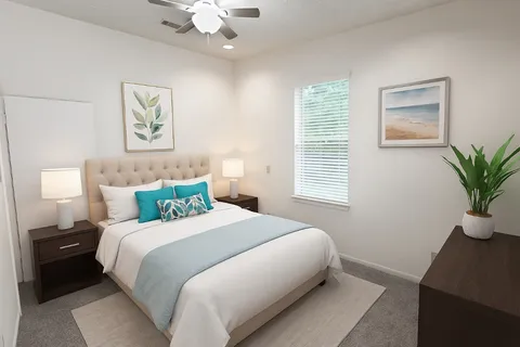 a bedroom with a large bed and a potted plant