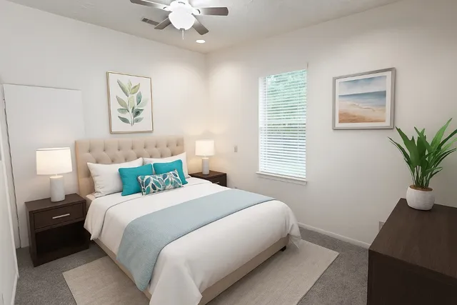 a bedroom with a large bed and a potted plant