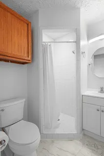 a white toilet sitting next to a bathroom sink