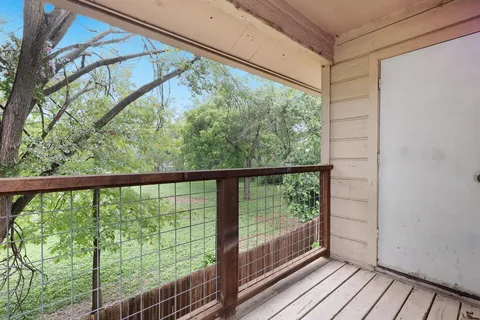 a view of a balcony with wooden floor