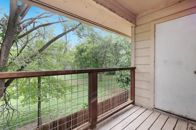 a view of a balcony with wooden floor