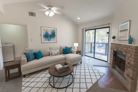 a living room with furniture a fireplace and a flat screen tv