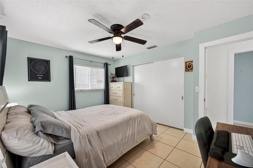 532 Center Road Venice, FL 34285 - Photo 29 of 68 a bedroom with a bed and a chair